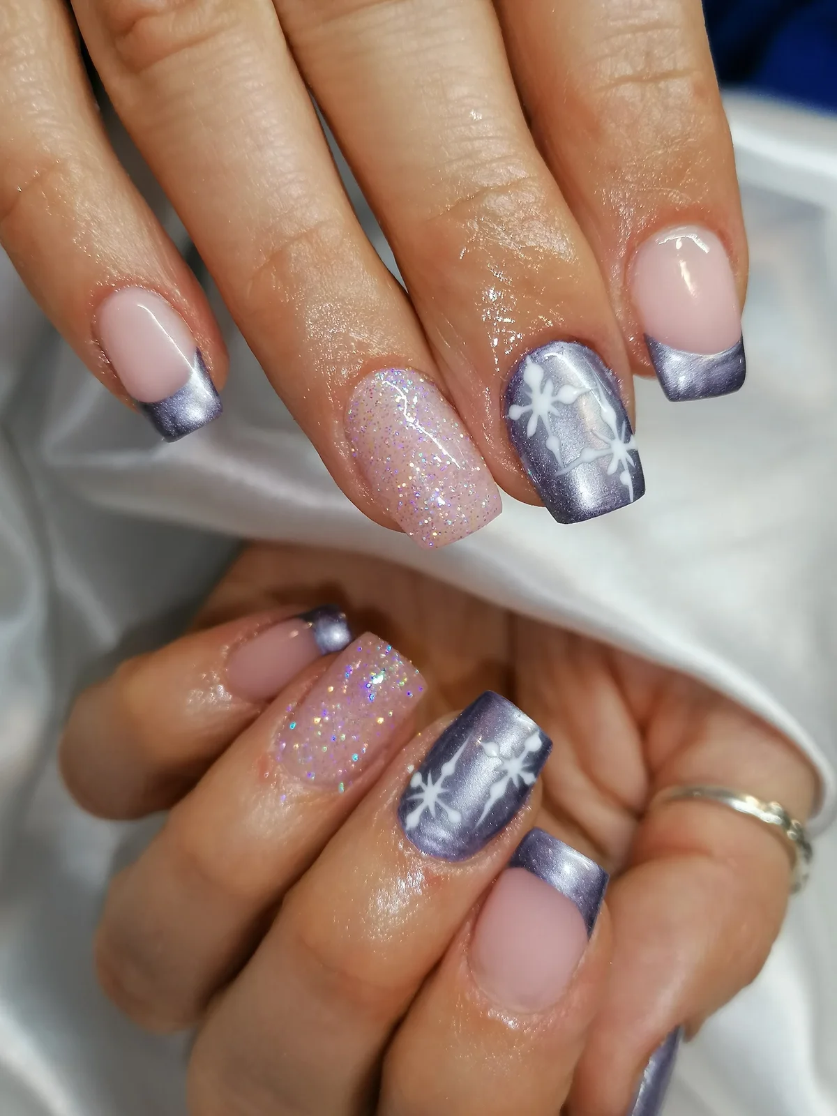 Silver French tips with glitter and delicate white snowflake details