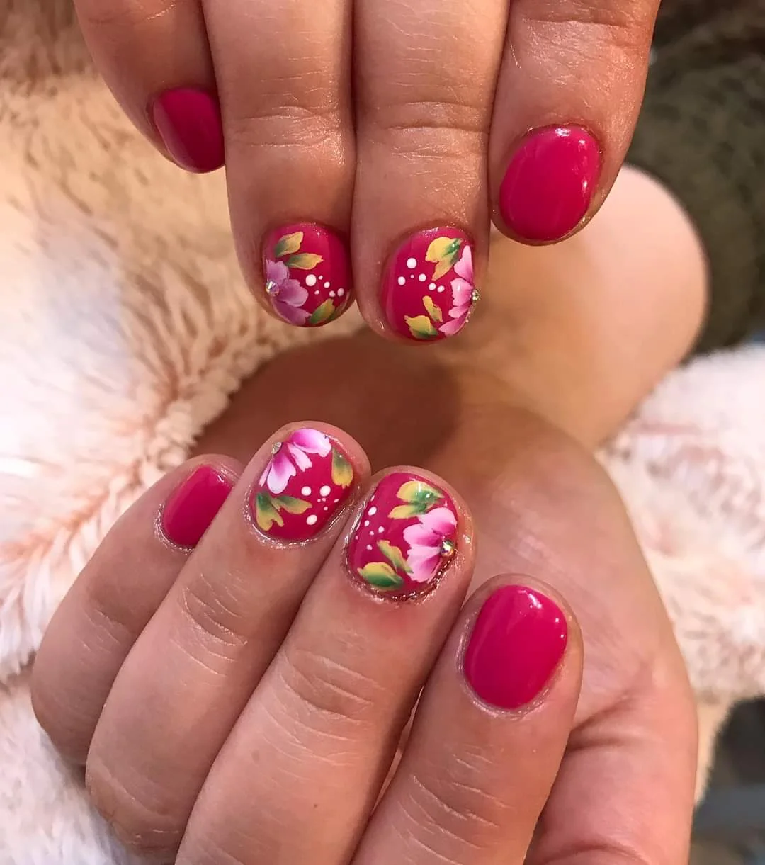 Bright pink nails with colourful floral nail art